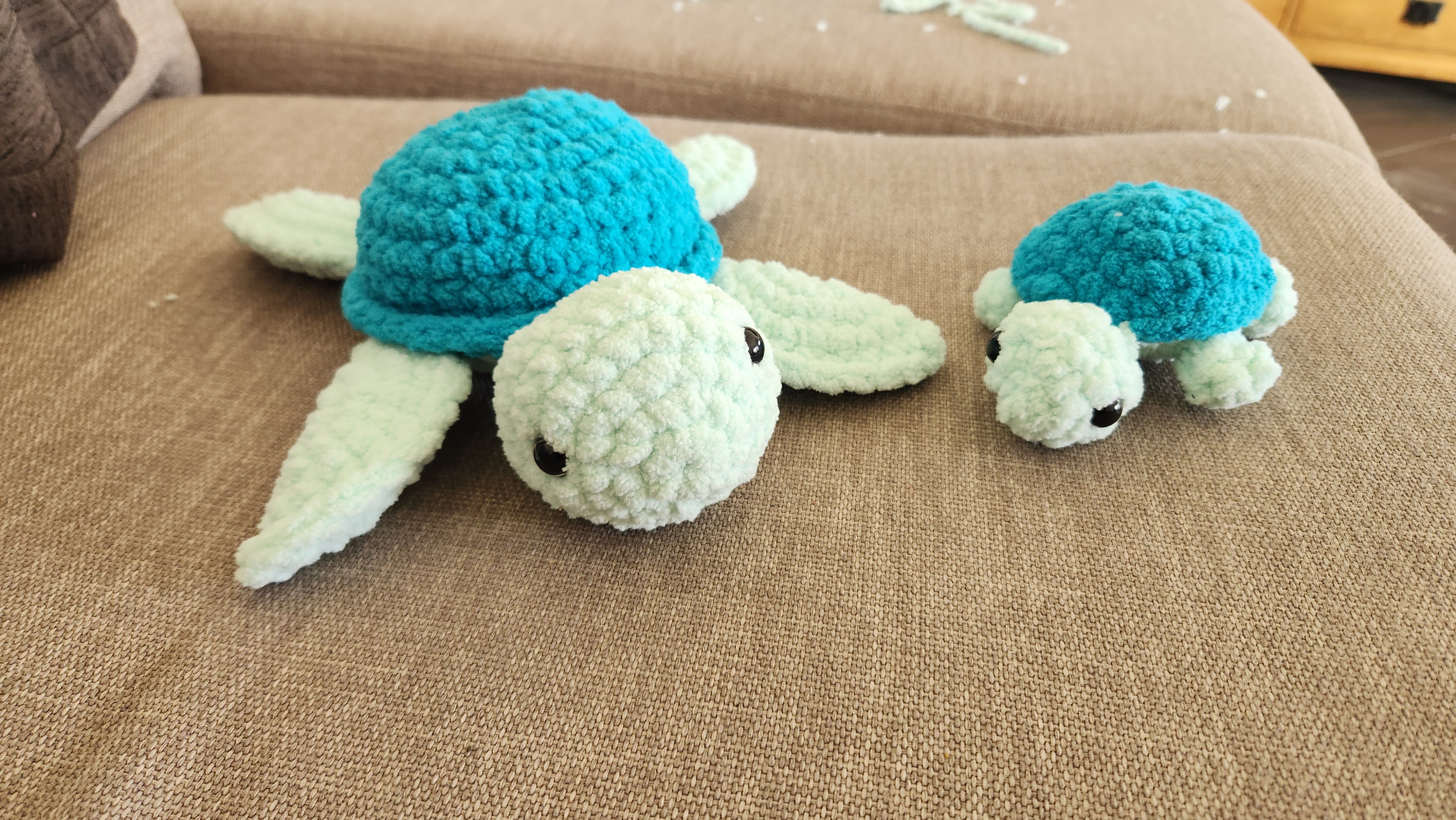 Two chenille crocheted sea turtles in teal and mint