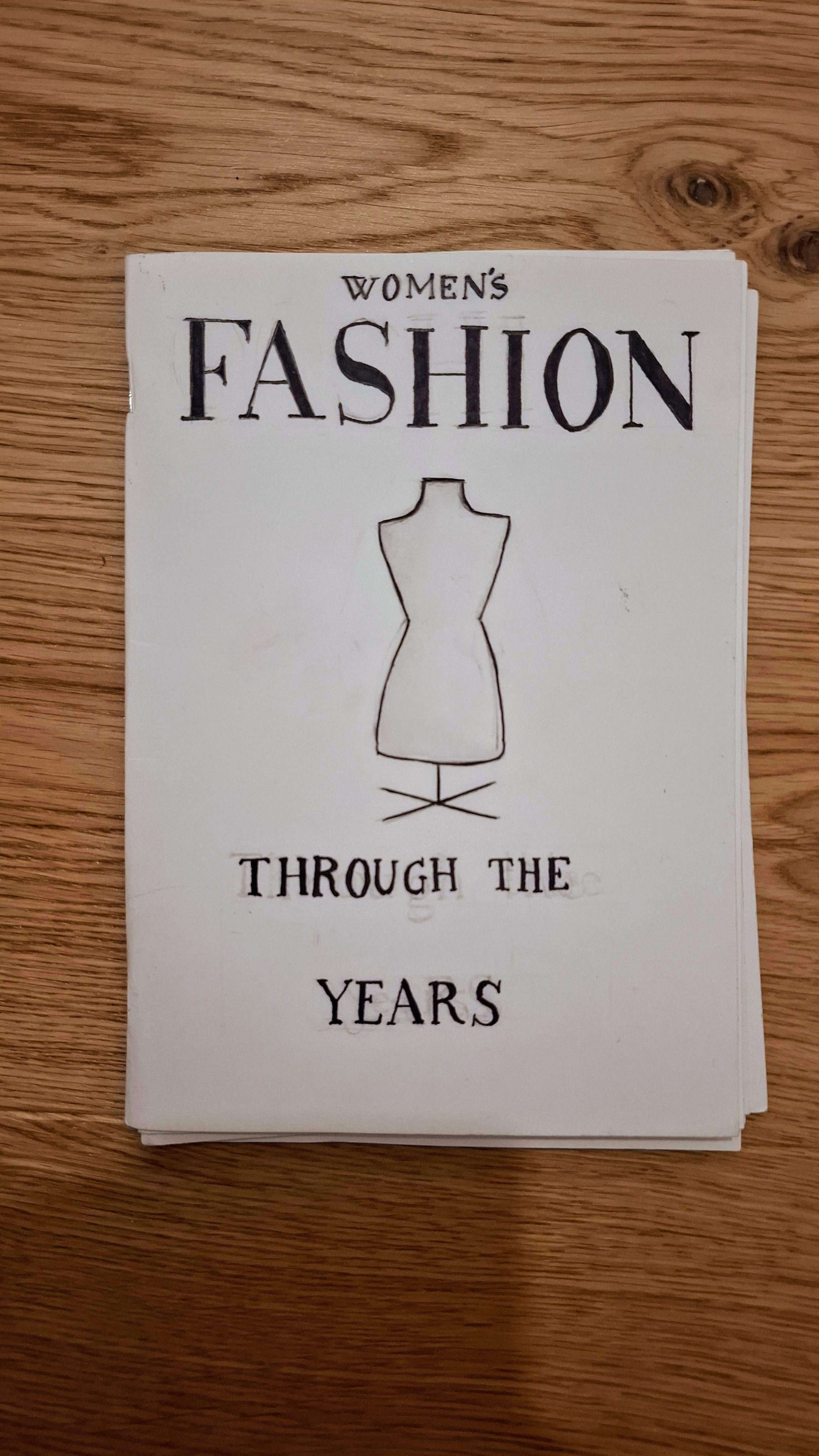 Hand-drawn cover reading Women's Fashion Through the Years with an illustrated dress form
