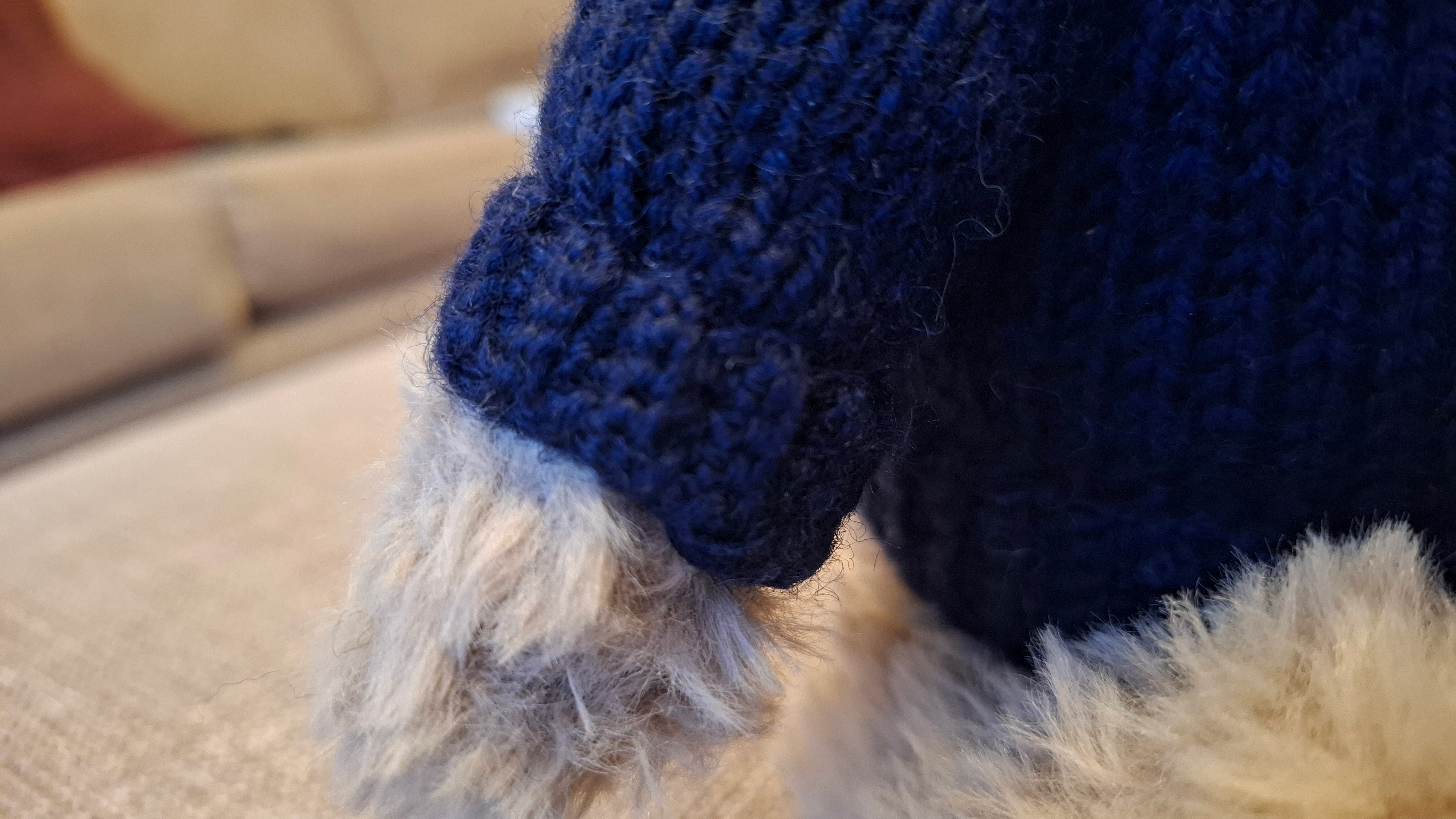 Close-up of the knitted navy Guernsey jumper with ribbed cuff