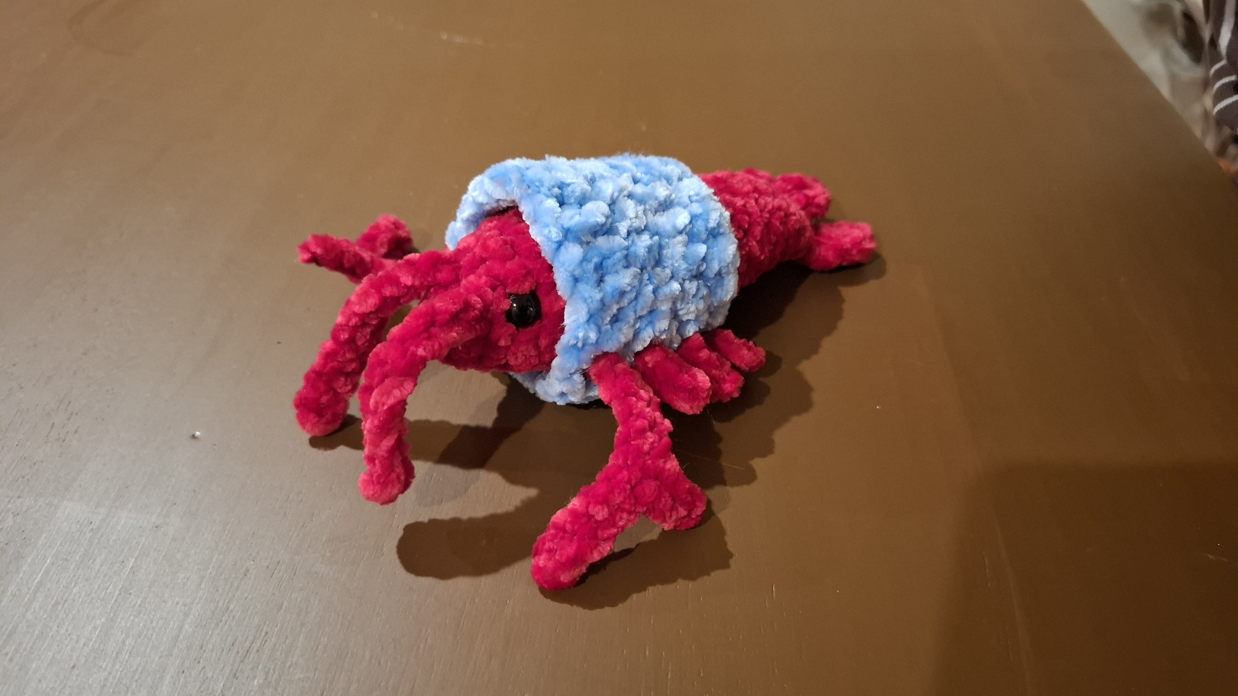 Rob the Lobster — a red crochet lobster with a blue shell