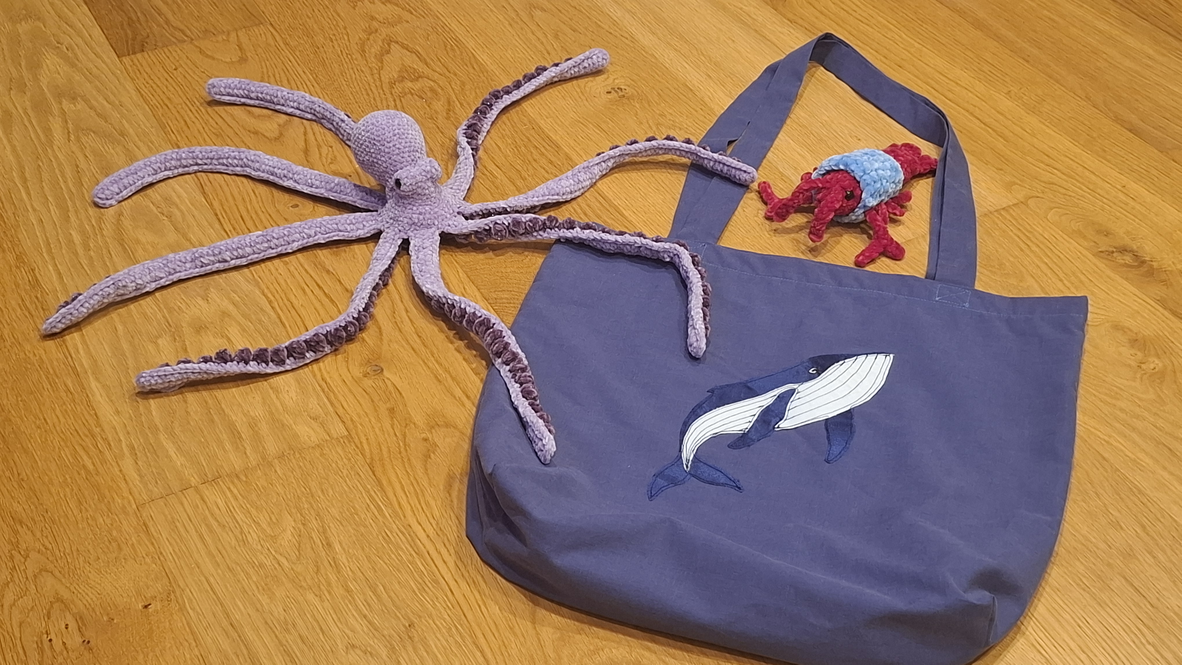 The whale tote bag with a crochet octopus and Rob the Lobster
