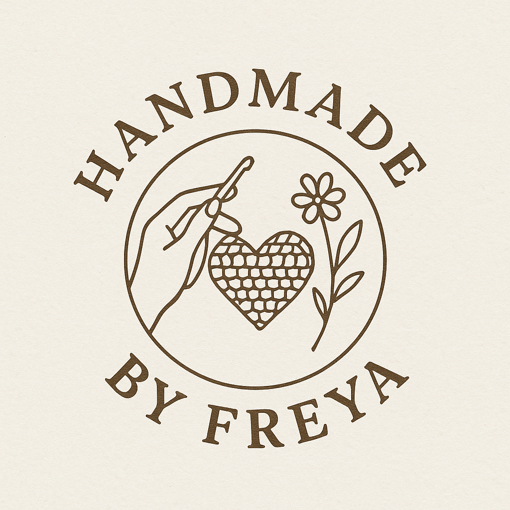 Handmade by Freya logo — a hand holding a crochet hook working a heart, beside a flower